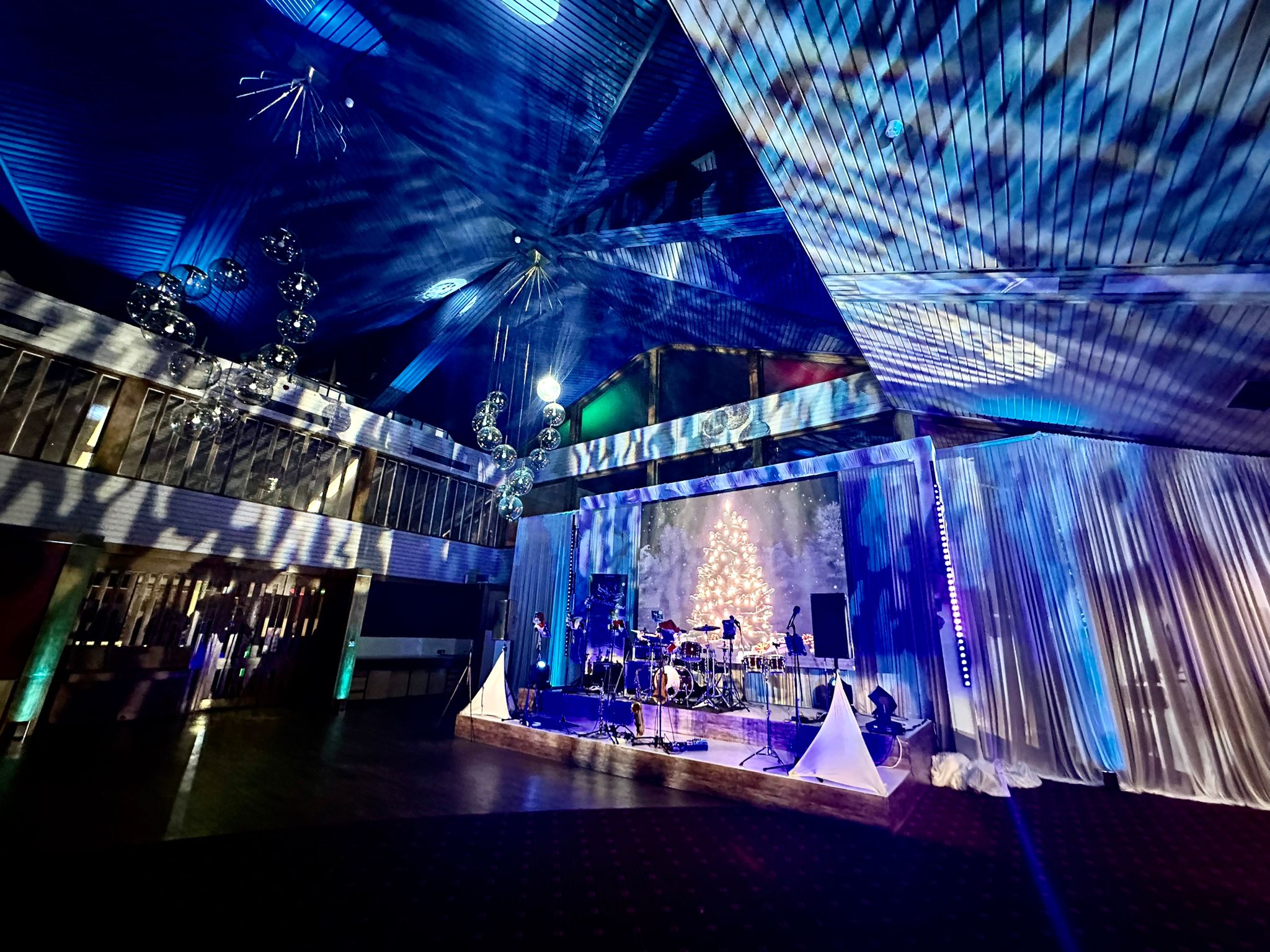 Event production with a live music stage, festive display and atmospheric lighting