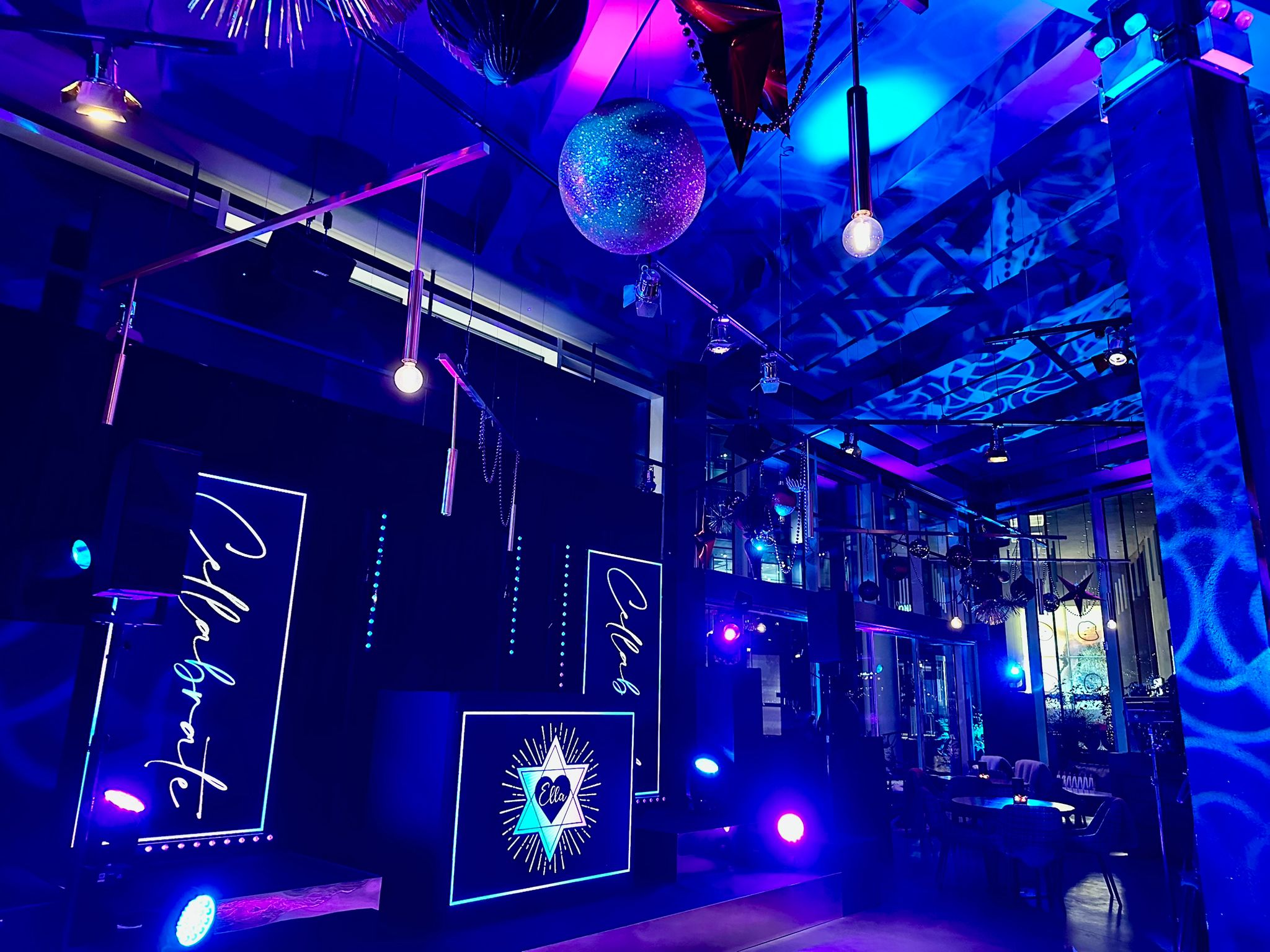 Ella’s personalised stage with blue lighting and suspended glittering decorations